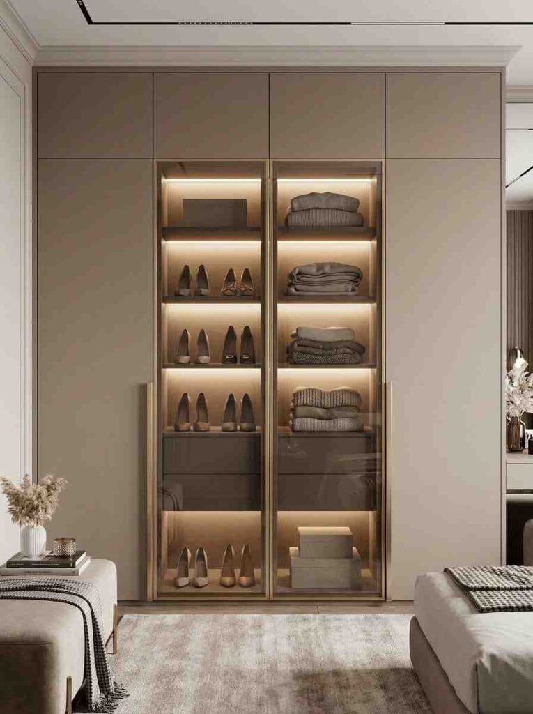 A bedroom wardrobe with two glass-front panels showing neatly arranged shoes and folded knitwear. 