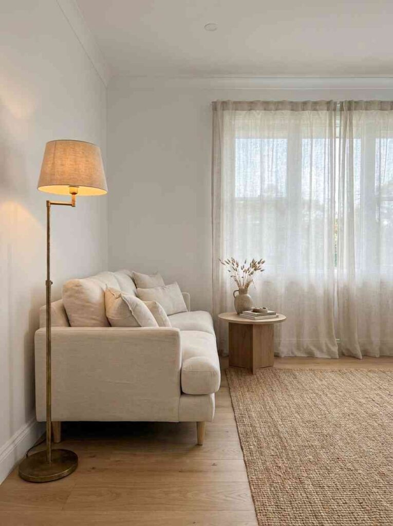  Cozy white built in banquette seating nook by a large window, cream cushions