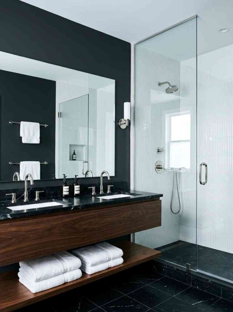 20 Bathroom Ideas 2026 A sophisticated black and white modern bathroom with a deep charcoal feature wall painted in Benjamin Moore